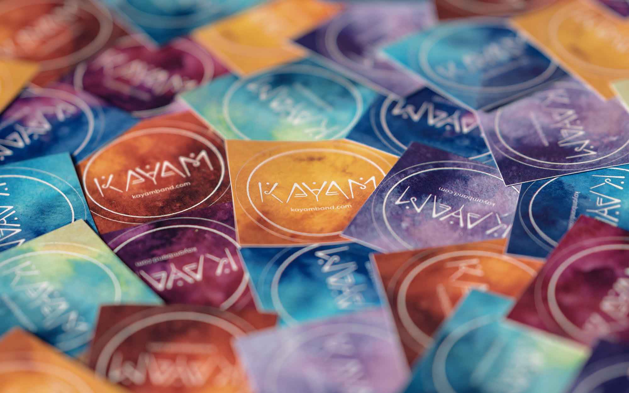 KAYAM merch: A pile of multi-coloured stickers
