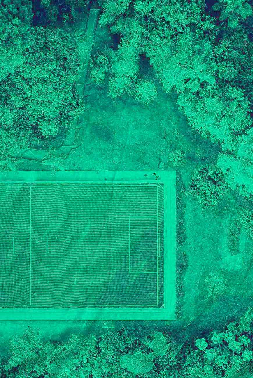 leAD: Tennis court surrounded by trees